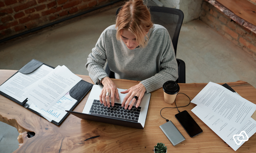 Employee uses time tracking on a laptop to measure and analyse actual working time.