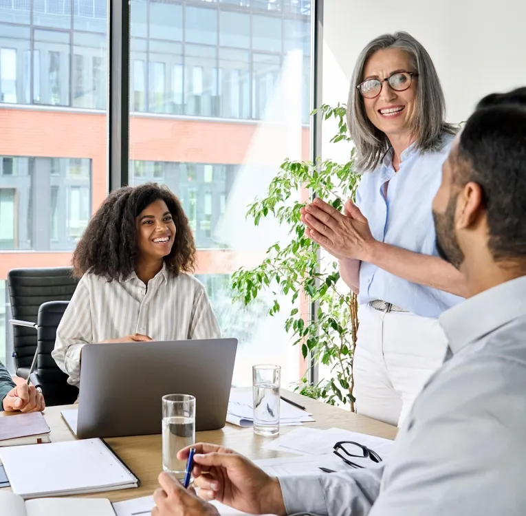 Diverse business team in a modern office engaged in a collaborative meeting, discussing workforce strategies and innovation.
